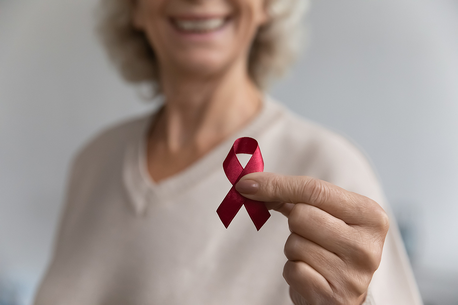 Closeup Image Aged Female Show To Camera Red Ribbon Symbol