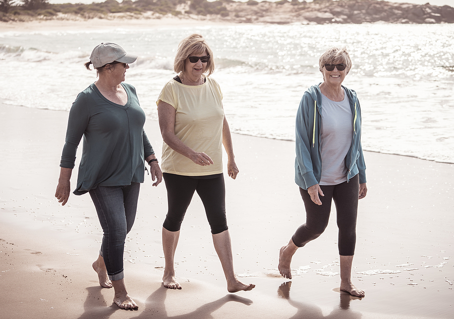 Lovely Group Of Three Active Senior Woman On Their 60s Walking,