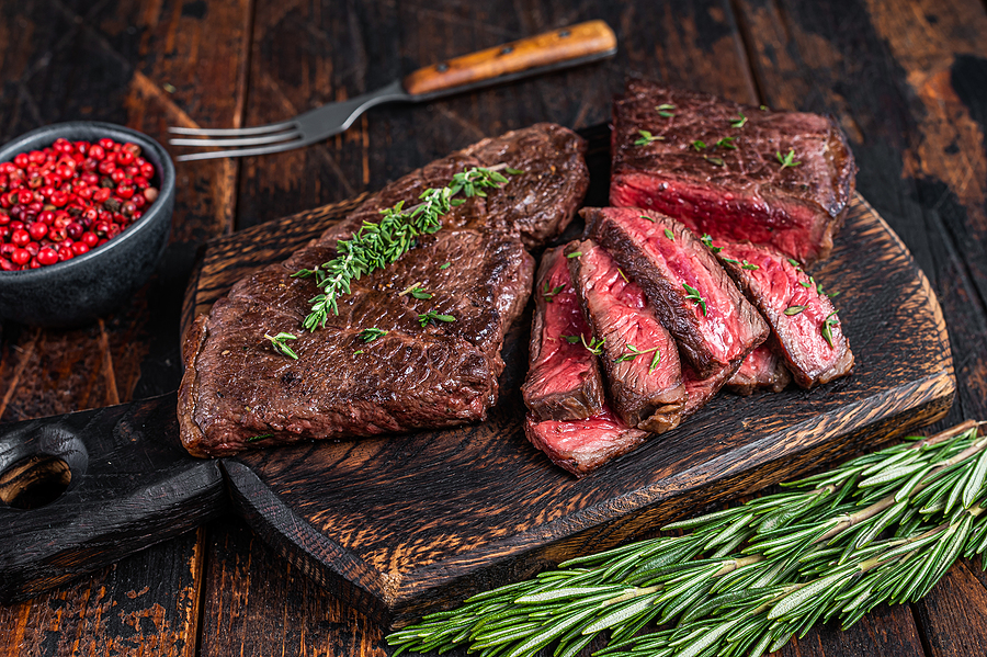 Grilled Sliced Skirt Beef Meat Steak On A Cutting Board With Her