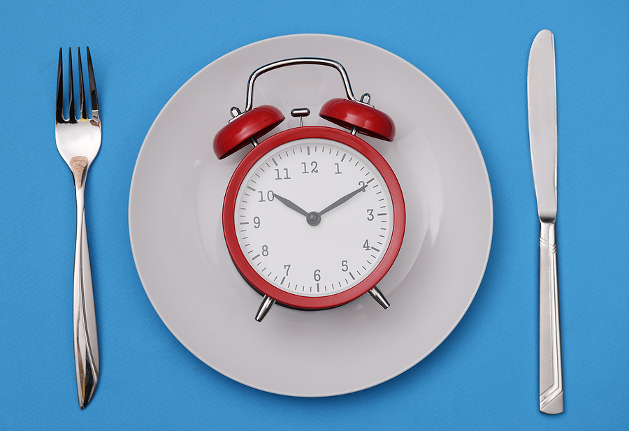 There Is A Red Alarm Clock On White Plate. Diet Regimen And Heal