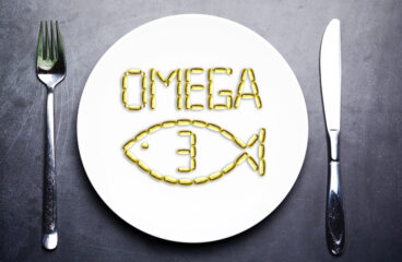 Omega 3 From Salmon Oil Capsules On White Plate With Fish Shape