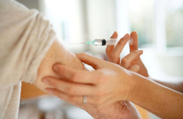 Close Up Of Senior Woman Geting Flu Shot