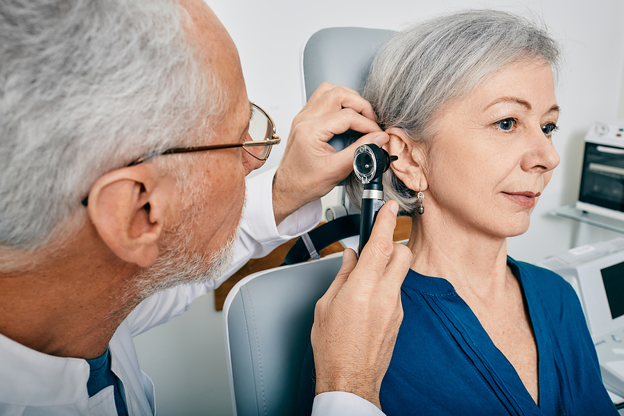 Otolaryngologist Doctor Checking Senior Womans Ear Using Otoscop