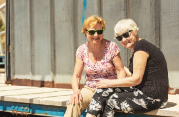 Two,smiling,elderly,women,are,happy,to,meet,each,other,