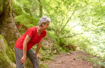 Older Woman Regaining Strength After Ascending A Slope In The Fo